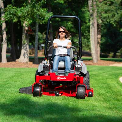 Woman driving lawn mower