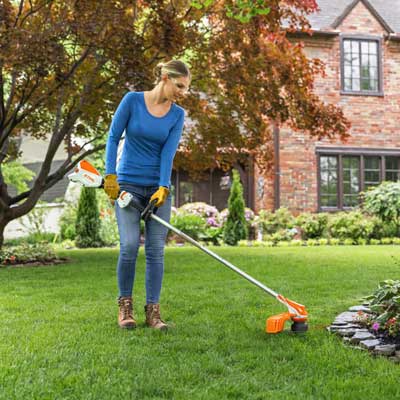 Woman with weed whacker